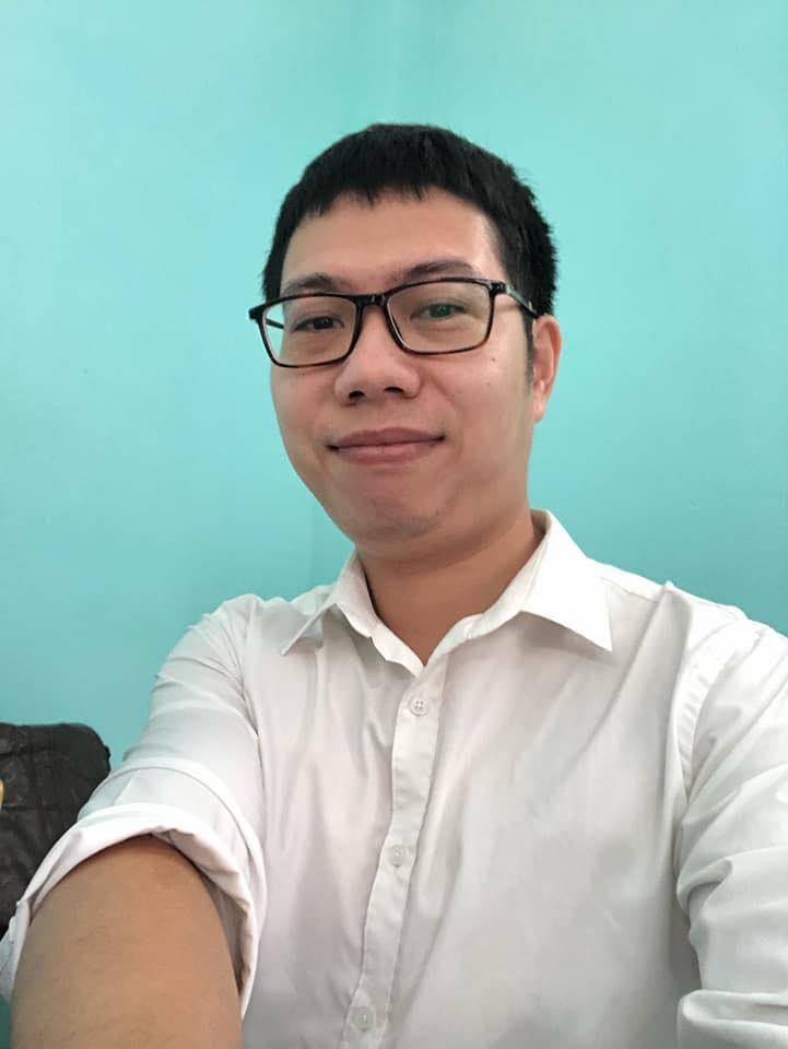 A headshot of a man wearing glasses